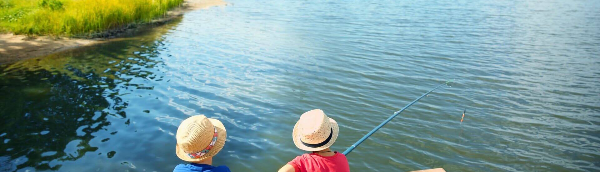 two young boys fishing on docks of great lake