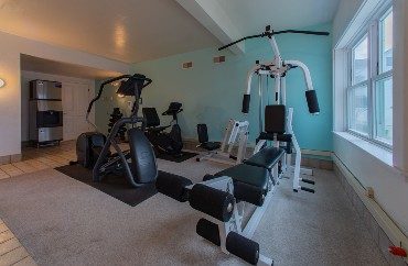 Fitness room with several machines and large picture window